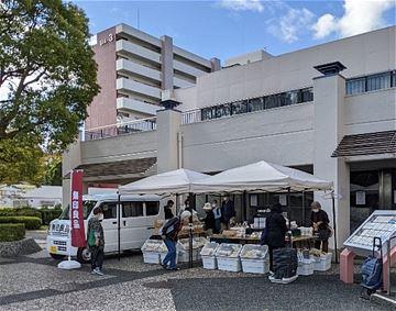 屋外に立つテントと無印良品ののぼり旗の写真