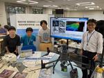 展示の前で生徒と記念撮影